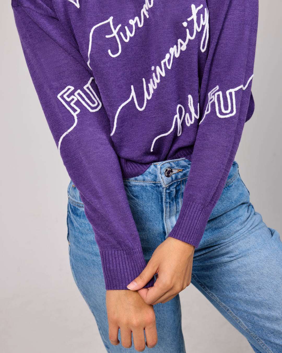 purple crewneck sweater with furman university paladins embroidery, styled for college game day