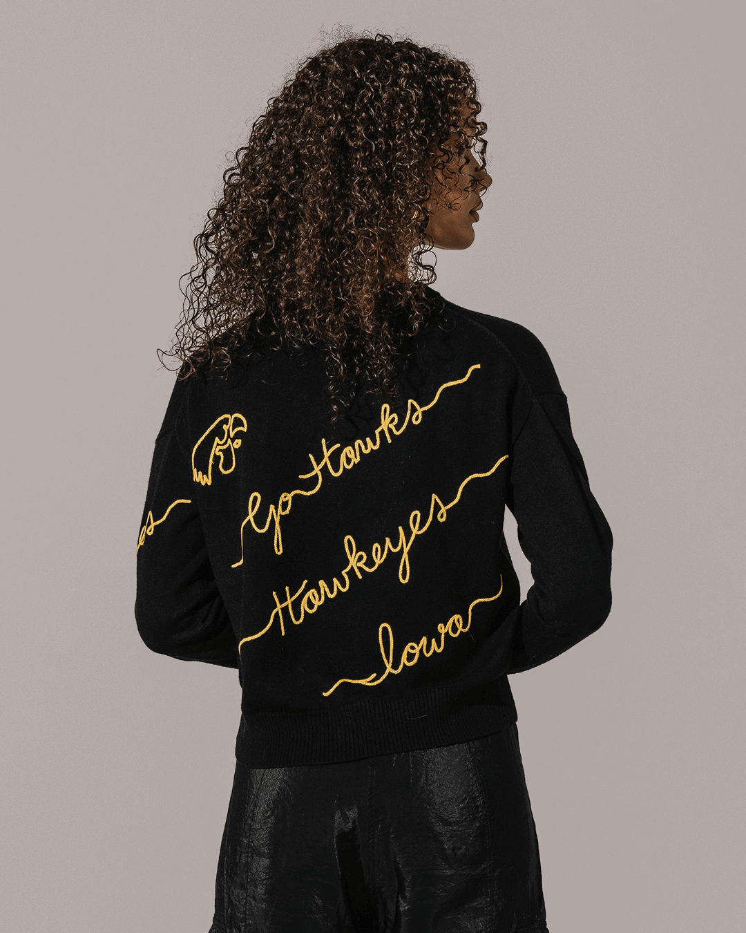 black crewneck sweater with iowa hawkeyes embroidery, styled for back to school