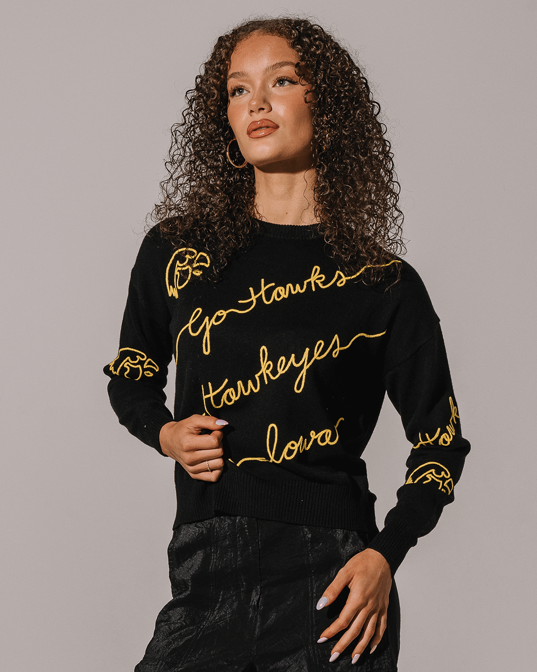 black crewneck sweater with iowa hawkeyes embroidery, styled for back to school