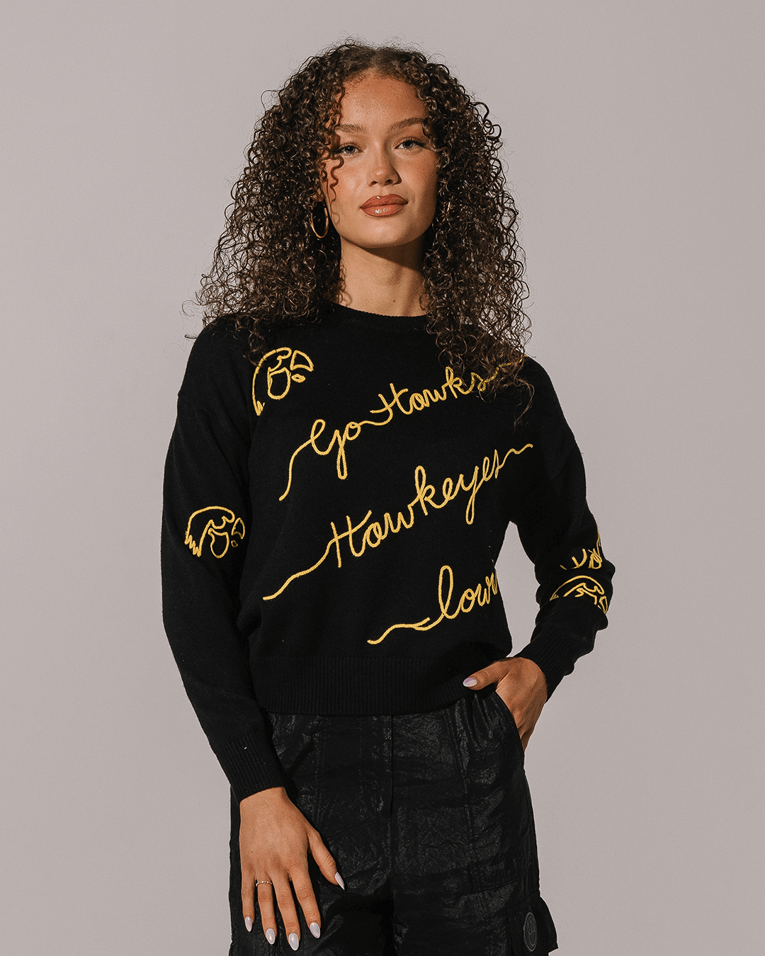 black crewneck sweater with iowa hawkeyes embroidery, styled for back to school