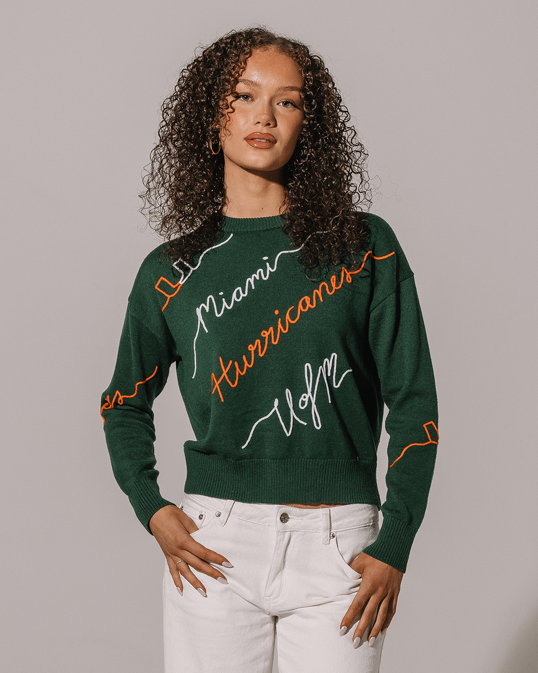 green crewneck sweater with umiami hurricanes embroidery, perfect for college game days.