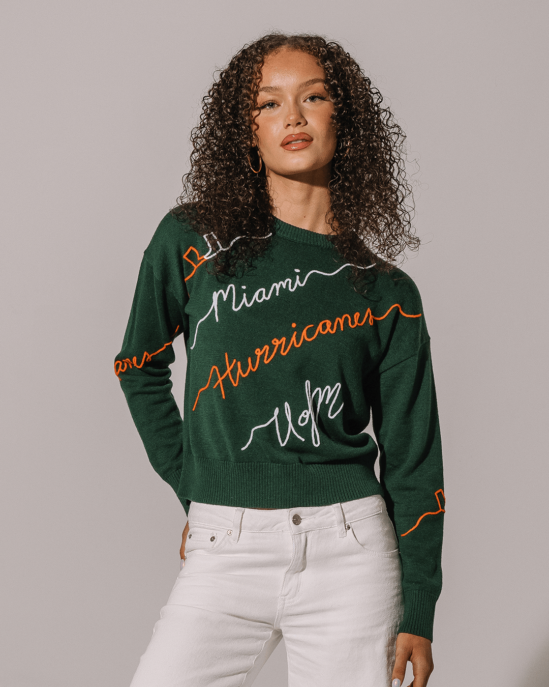 green crewneck sweater with umiami hurricanes embroidery, perfect for college game days.