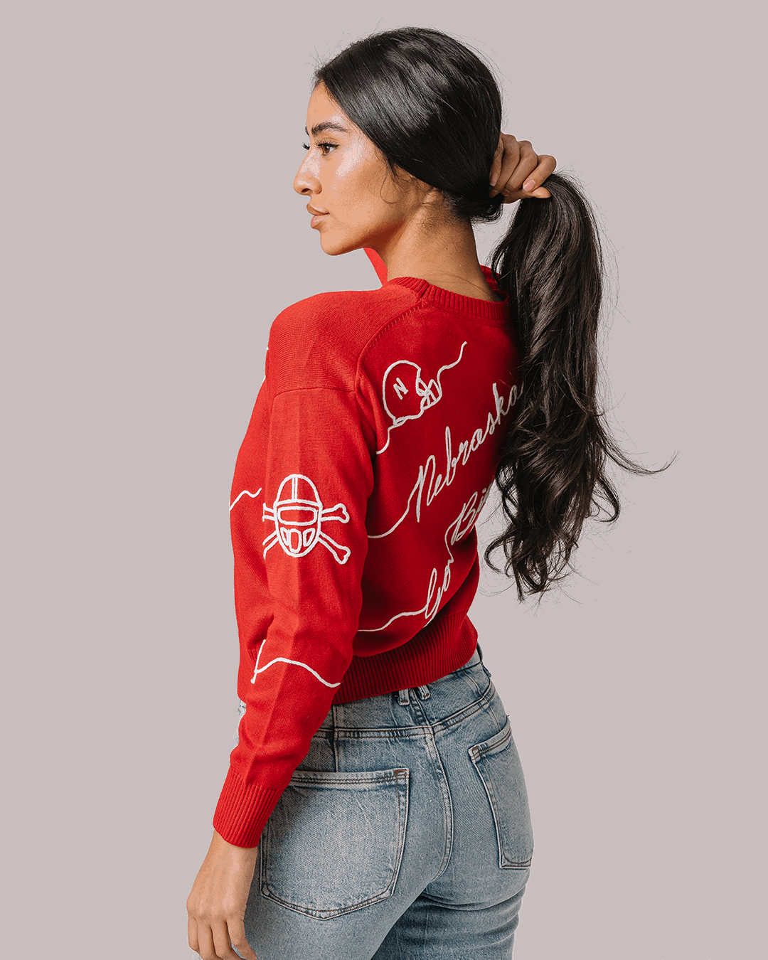 red crewneck sweater with nebraska cornhuskers embroidery, styled for college game day and tailgates