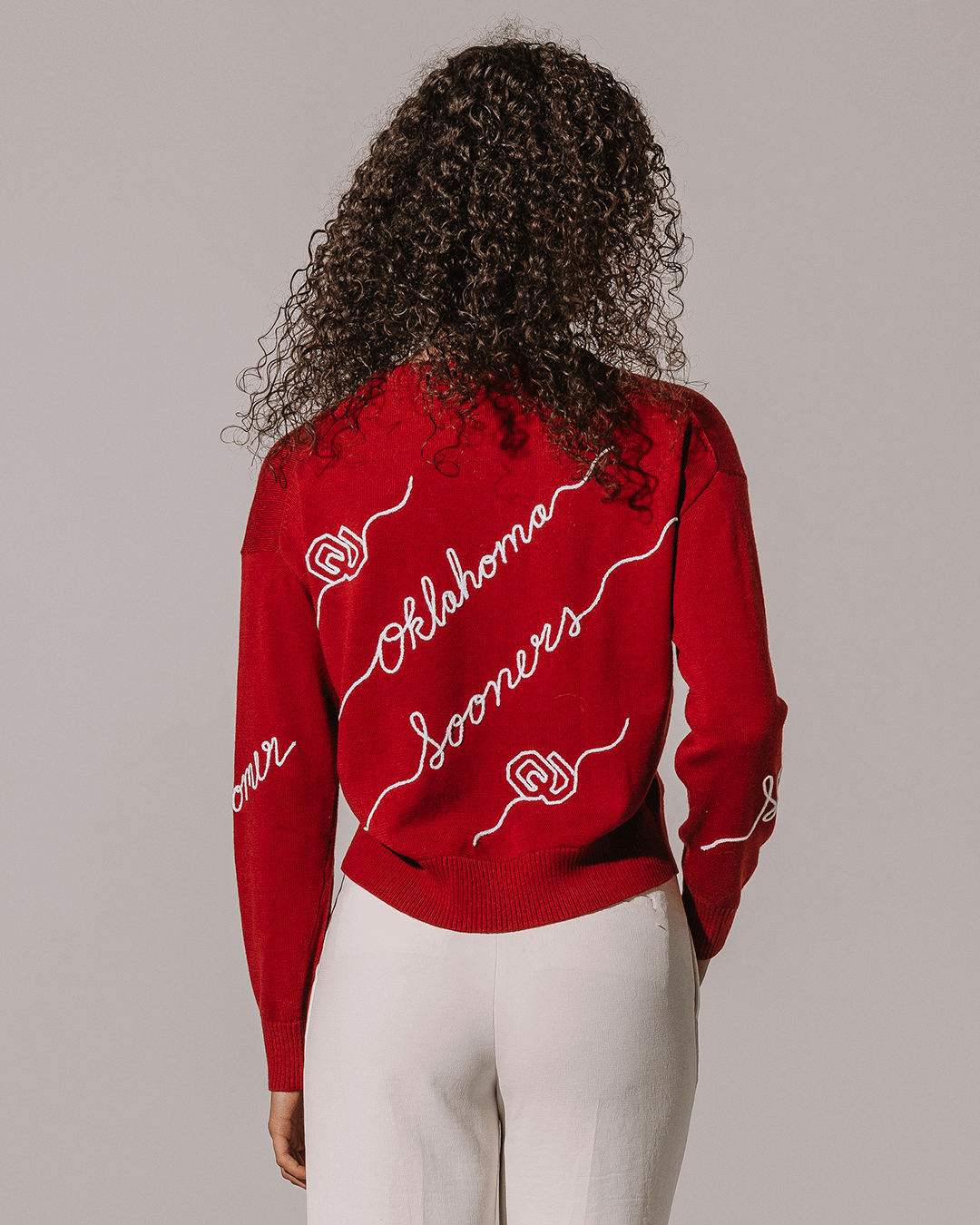 red crewneck sweater with oklahoma sooners embroidery, perfect for college campus.