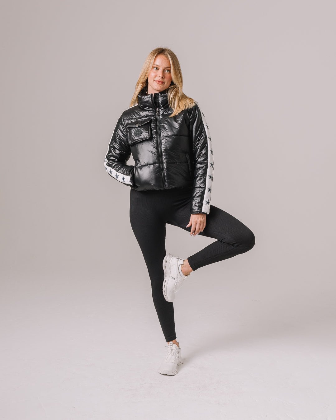 Black cargo puffer featuring Dallas Cowboys insignia, styled for tailgates, game day, or casual wear.