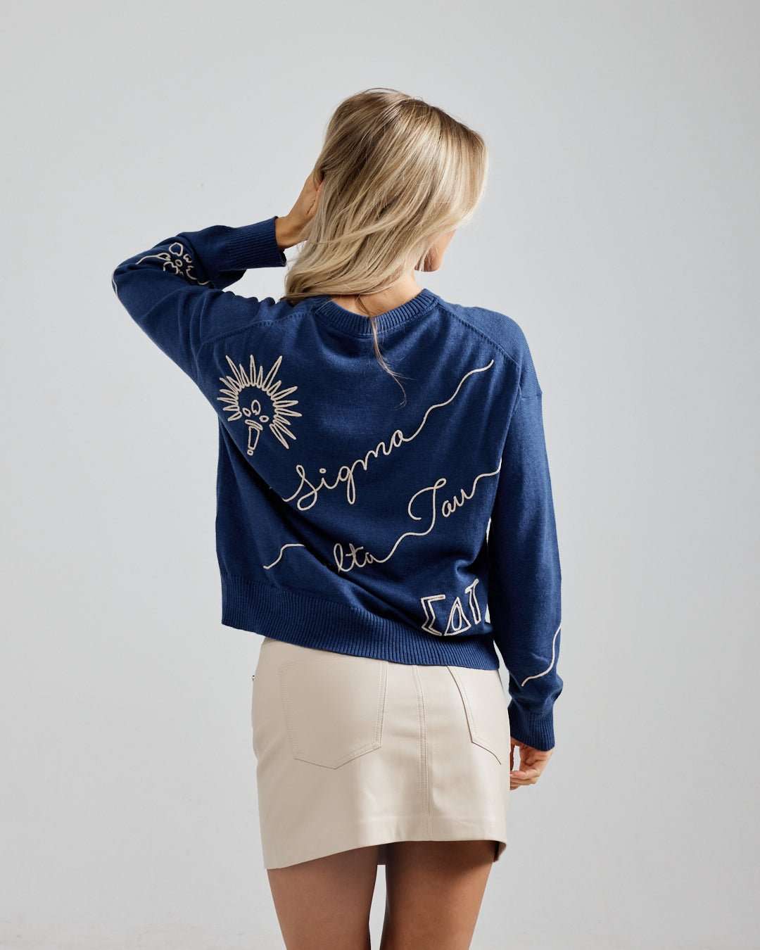 blue and beige crewneck sorority sweater with Sigma Delta Tau embroidered logo, perfect for sorority alumni brunch