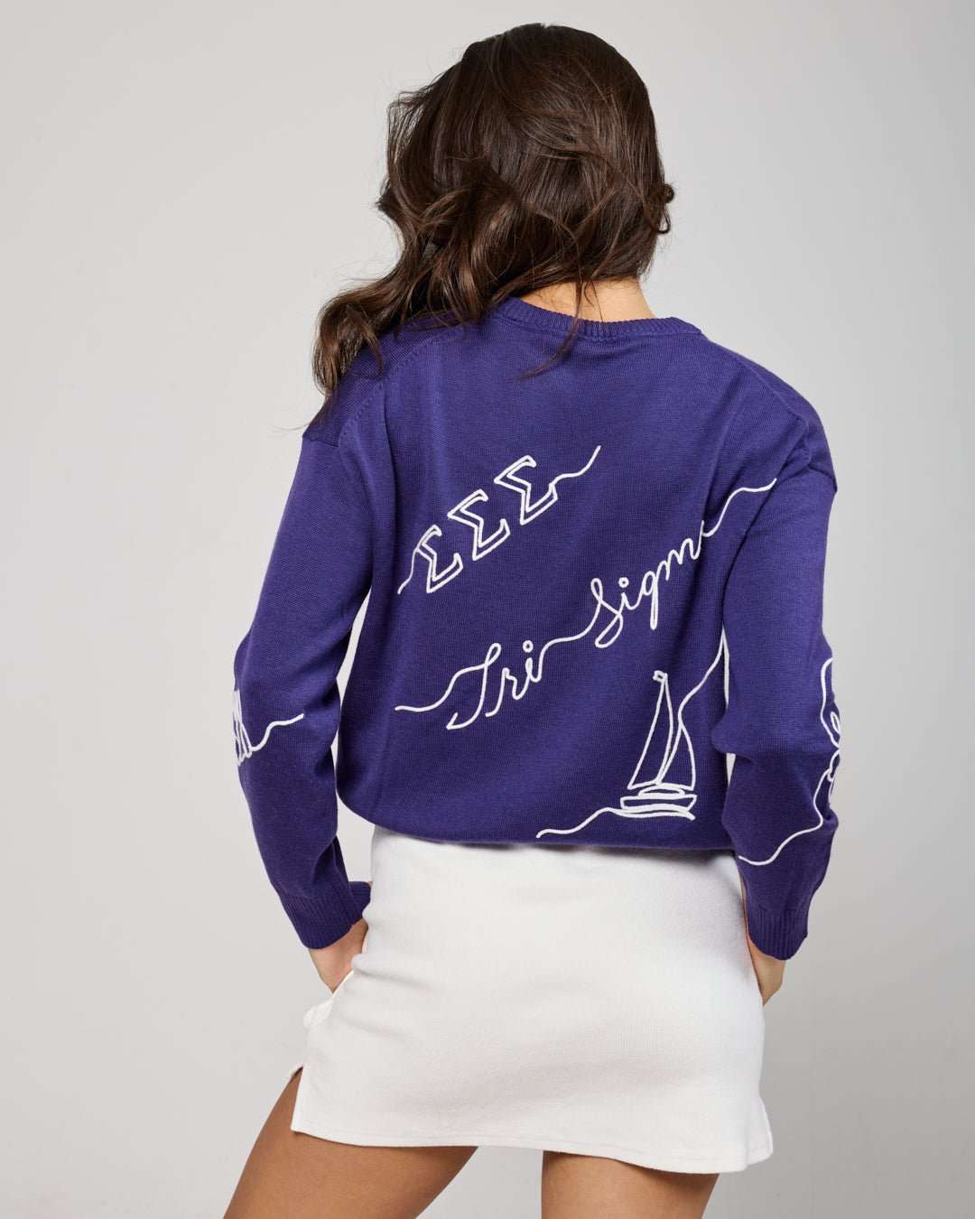 purple and white crewneck sorority sweater with Tri Sigma embroidered logo, perfect for college graduation photoshoot
