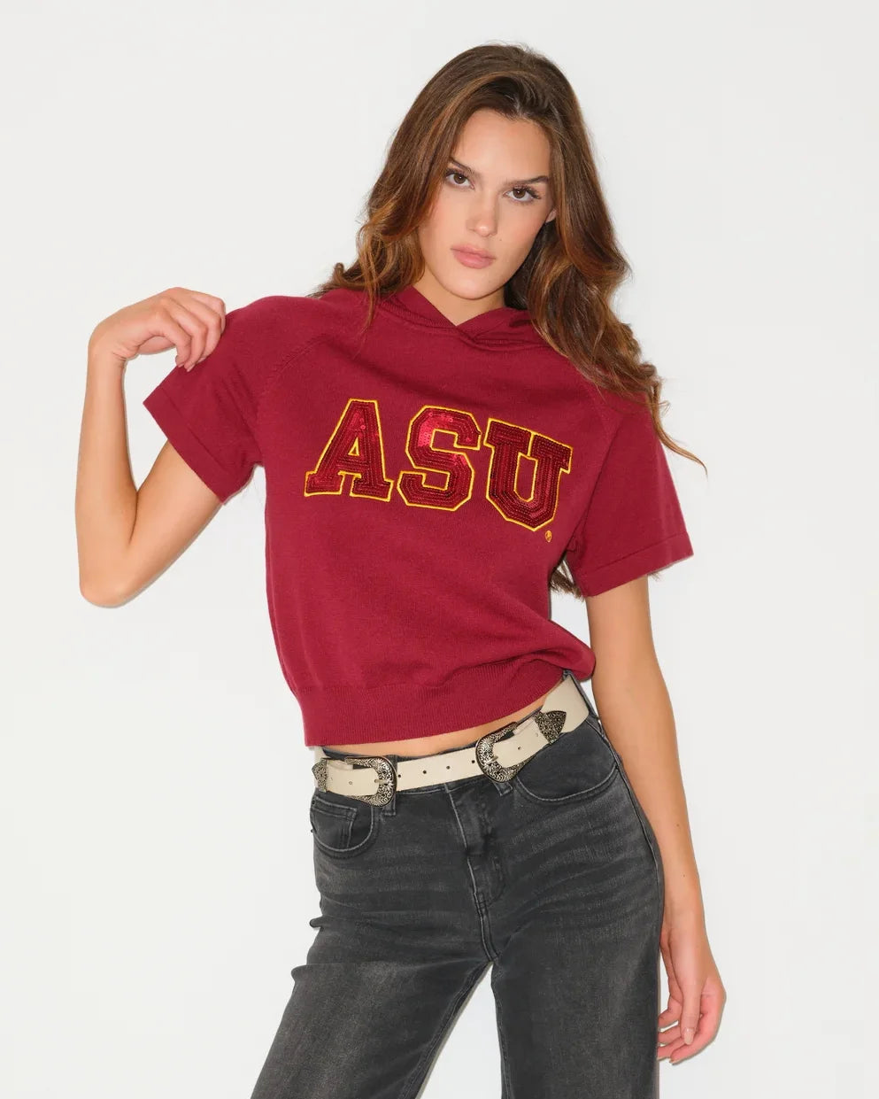 Maroon Arizona State Sun Devils sequin knit hooded top with bold "ASU" lettering, styled casually with wide-leg jeans.