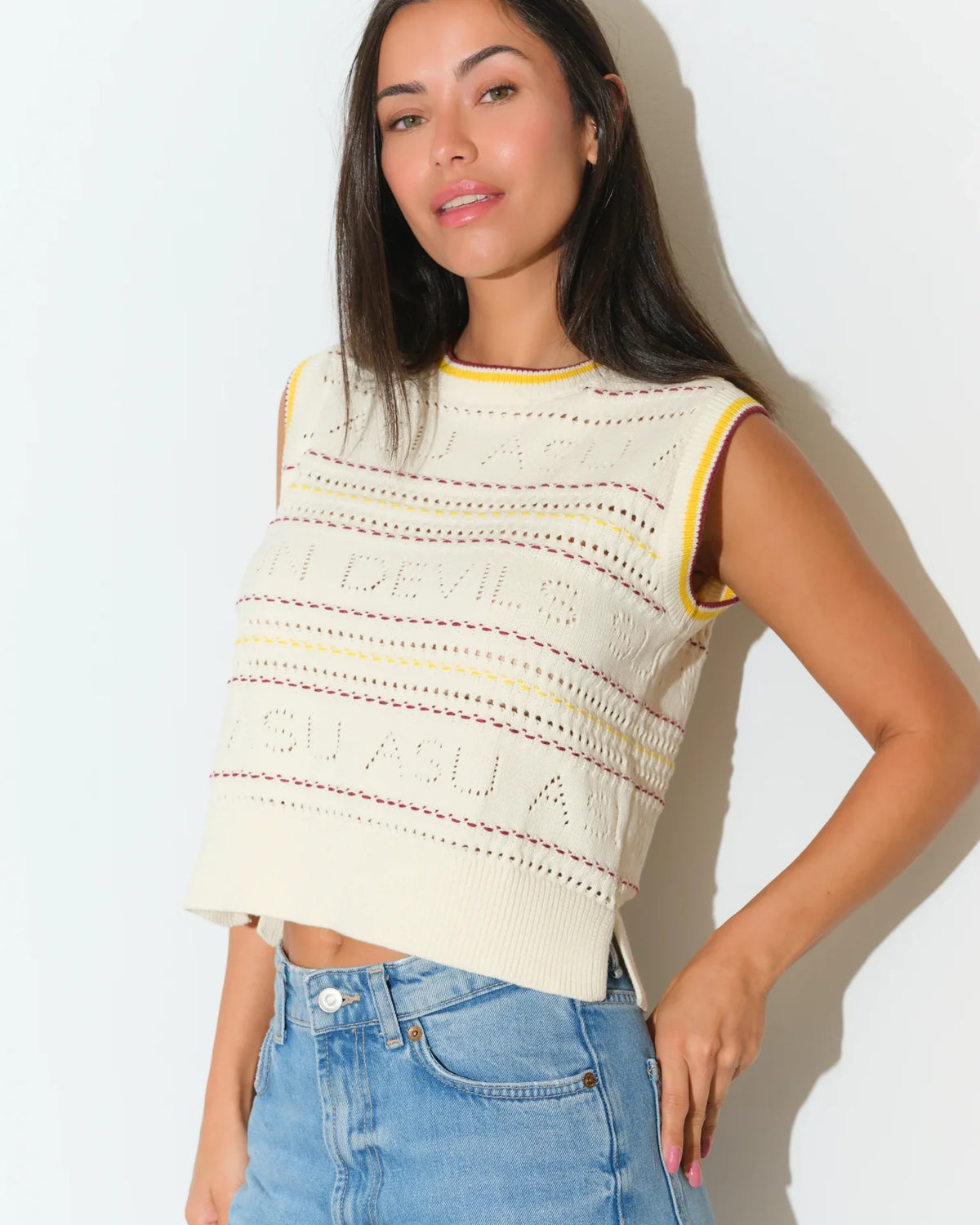 Ivory Arizona State Sun Devils sweater vest with colorful striped knit detailing, styled with light wash jeans.