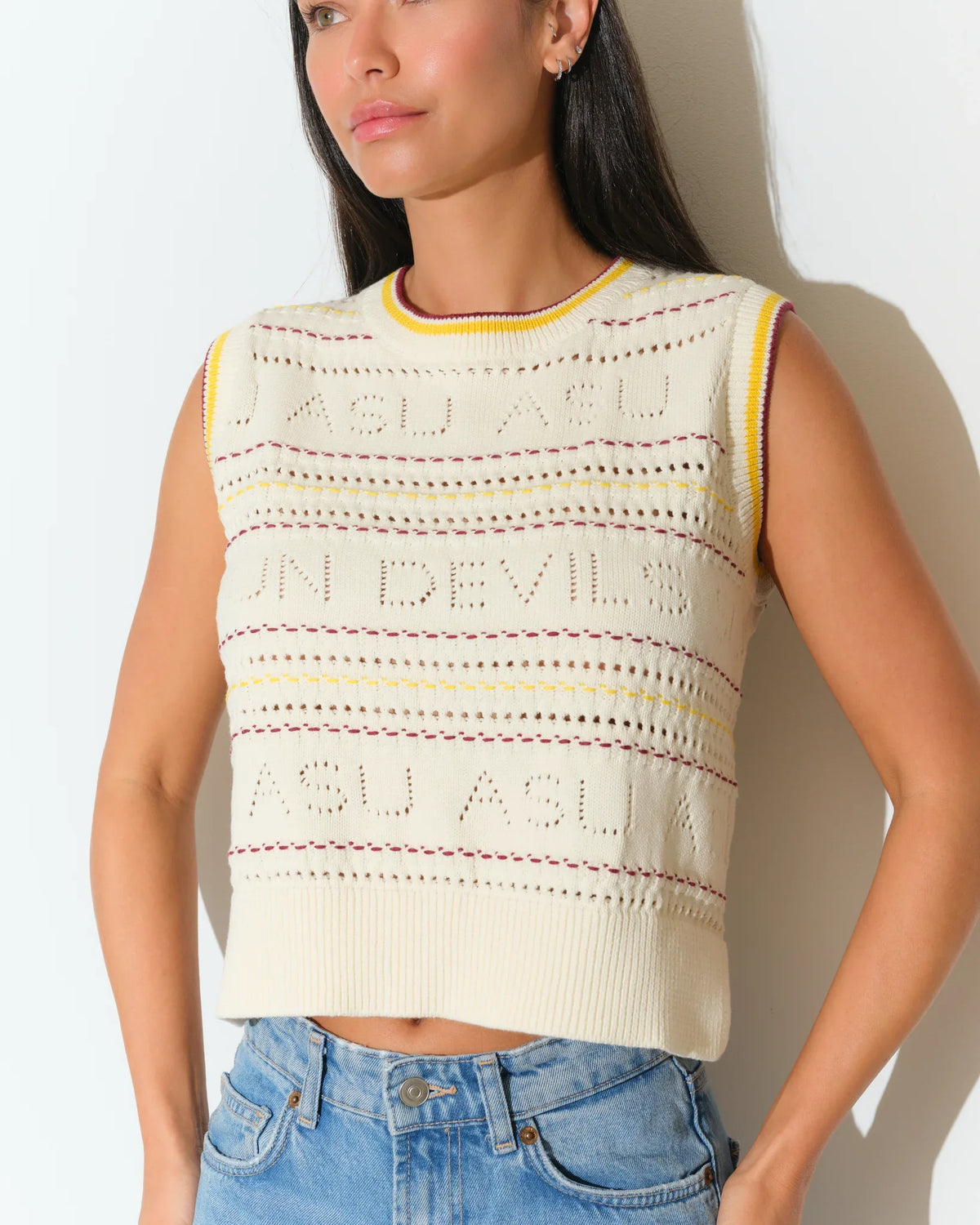 Ivory Arizona State Sun Devils sweater vest with colorful striped knit detailing, styled with light wash jeans.