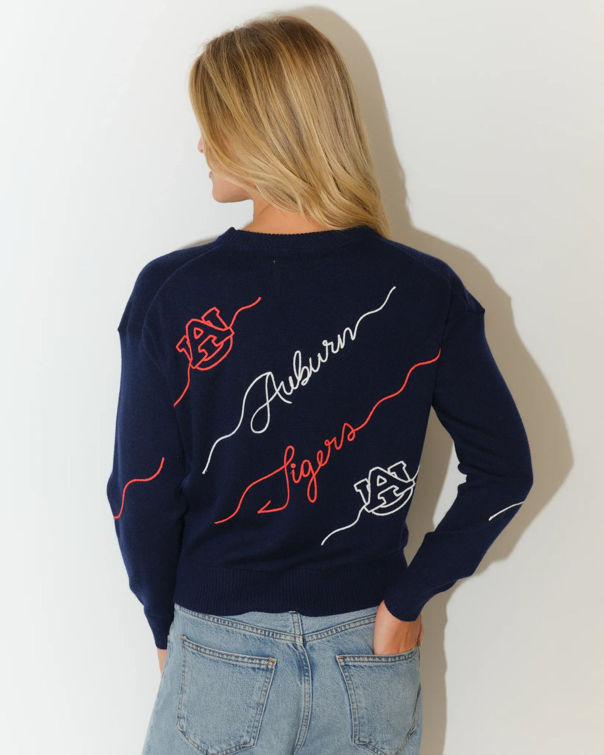 Navy Auburn Tigers Love Letter Sweater with red and white cursive script and floral embroidery details on a cropped crewneck silhouette.