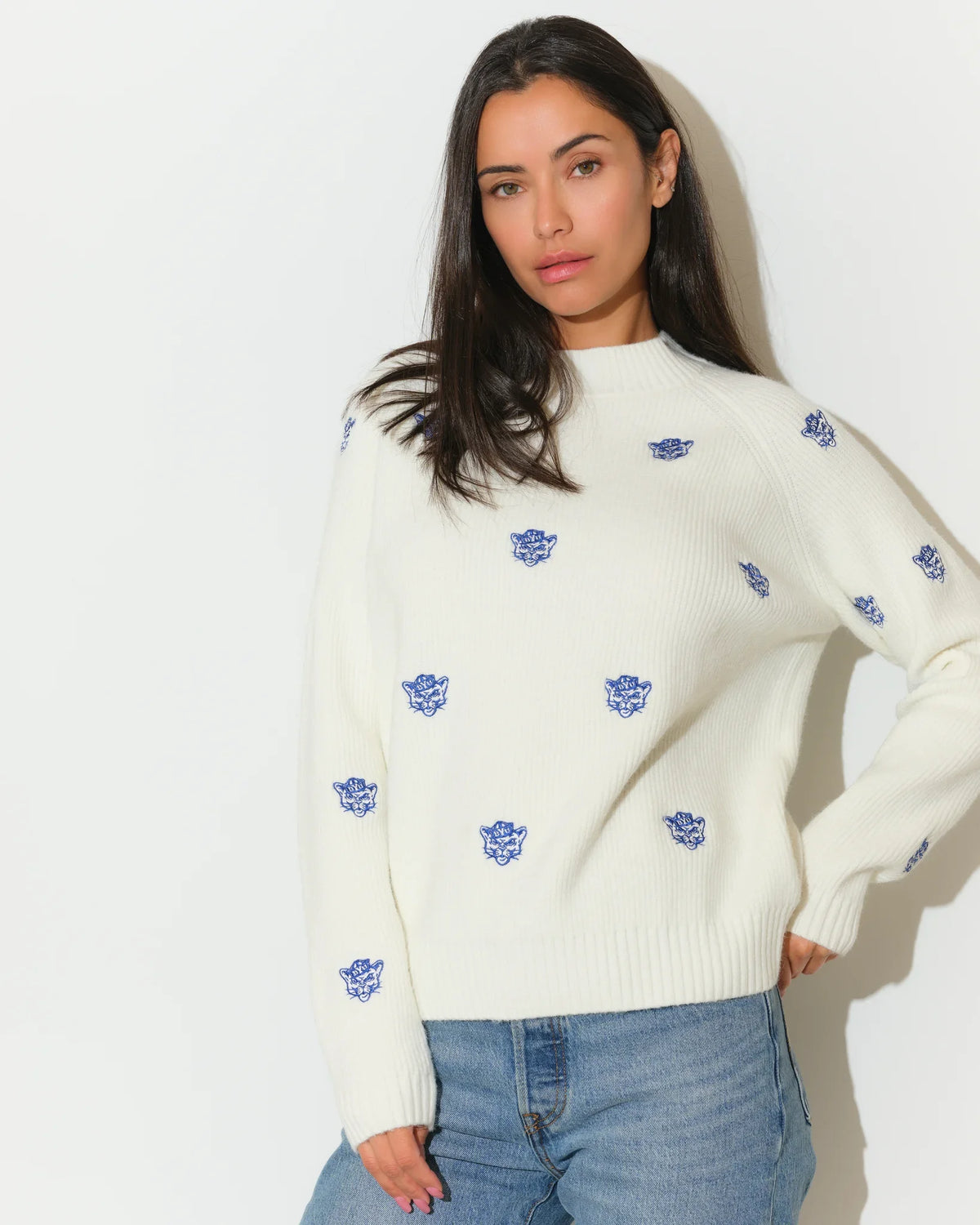Ivory BYU Cougars fisherman sweater with allover embroidered blue Cougar head logos, featuring a relaxed fit and ribbed hem.
