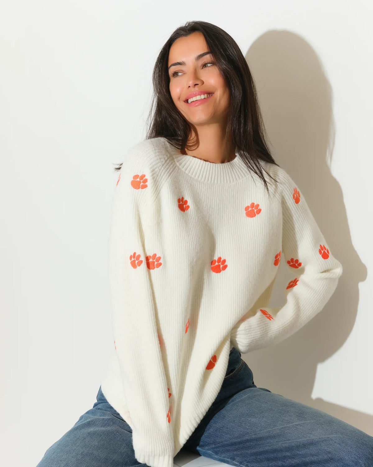 Ivory Clemson Tigers fisherman sweater featuring allover orange tiger paw embroidery, shown in a relaxed fit with a crew neckline.