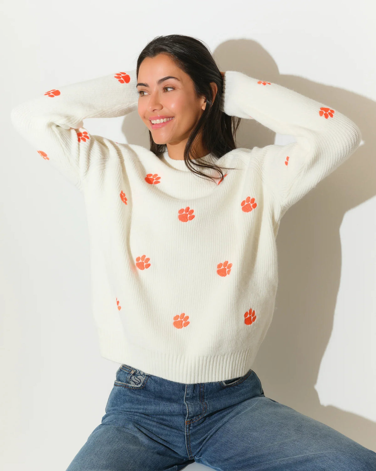 Ivory Clemson Tigers fisherman sweater featuring allover orange tiger paw embroidery, shown in a relaxed fit with a crew neckline.