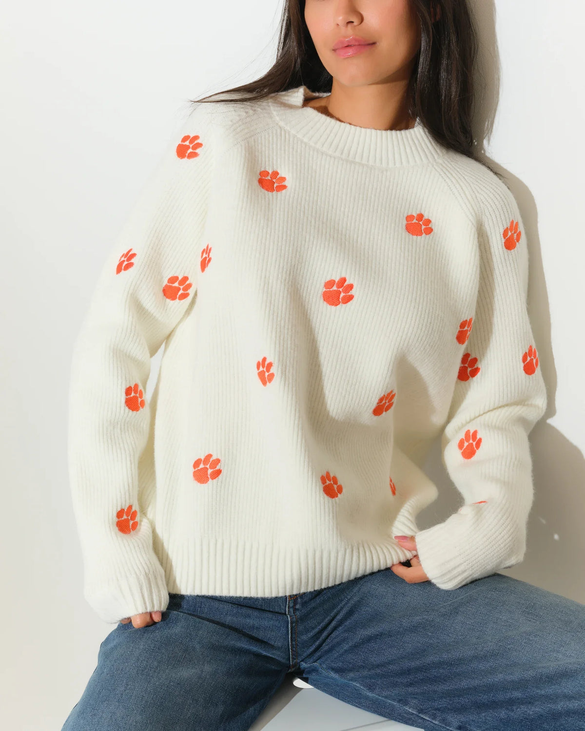 Ivory Clemson Tigers fisherman sweater featuring allover orange tiger paw embroidery, shown in a relaxed fit with a crew neckline.