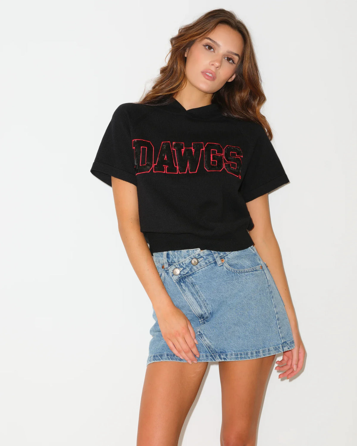 Black Georgia Bulldogs short sleeve shine knit hoodie with sequin team lettering, worn with a hood, styled casually.