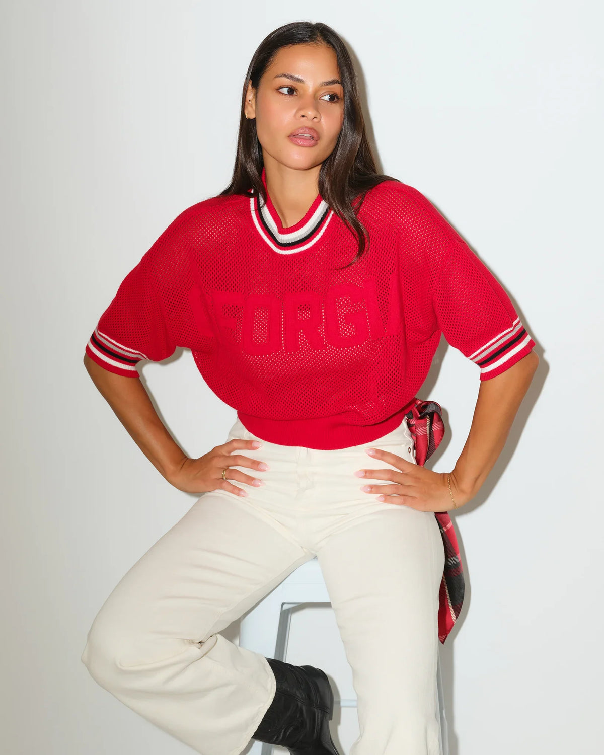 Red Georgia Bulldogs summer sweater with embossed lettering, striped ribbed collar, and short sleeves, styled with white pants.