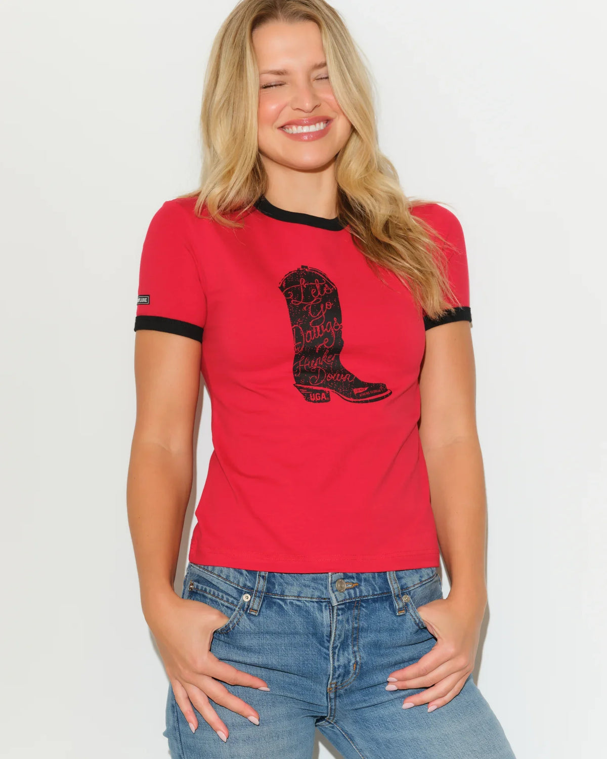 Red Georgia Bulldogs women's ringer tee with black trim and a cowboy boot graphic on the chest.
