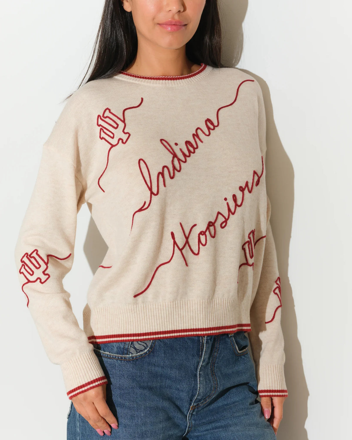 Crimson Indiana Hoosiers oversized knit sweater with white script "Indiana Hoosiers" lettering across the front, styled with white pants.