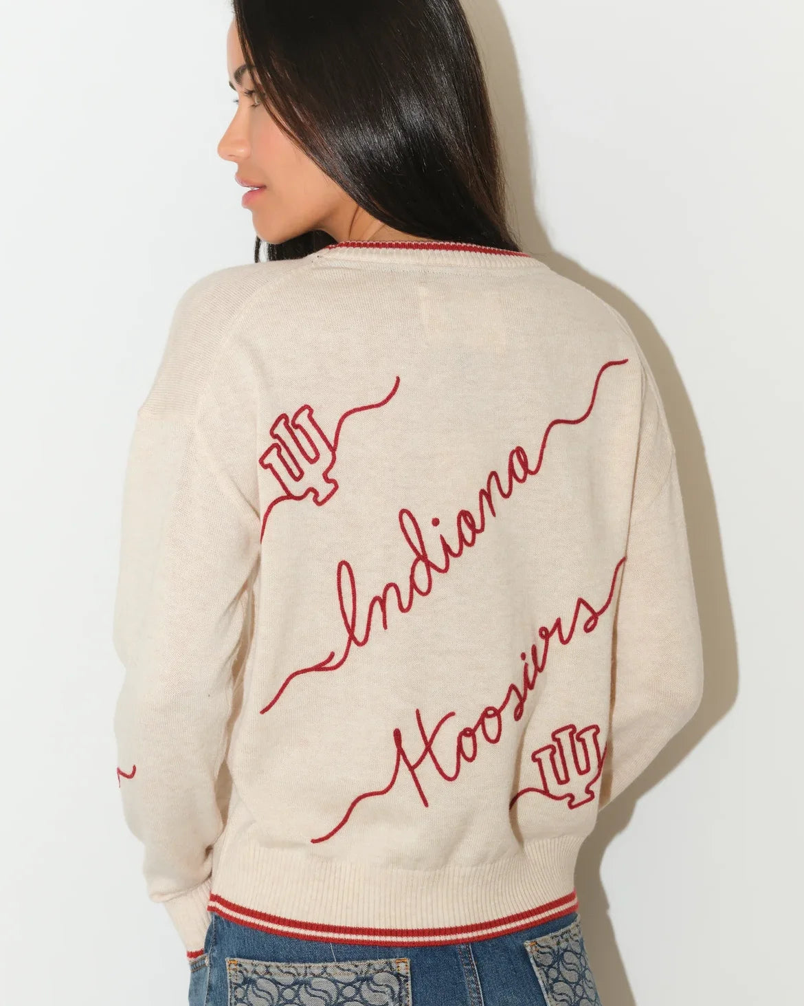 Crimson Indiana Hoosiers oversized knit sweater with white script "Indiana Hoosiers" lettering across the front, styled with white pants.