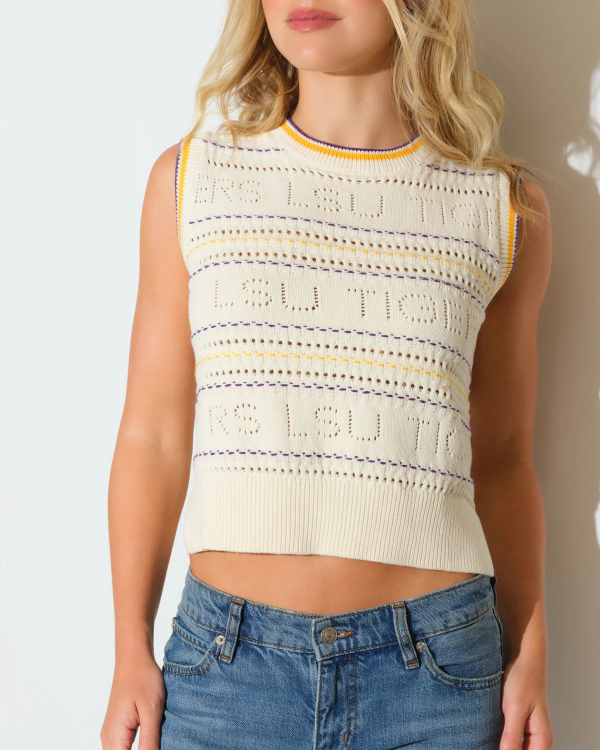 Ivory knit sweater vest for LSU Tigers fans, featuring embroidered team lettering and a striped crew neckline.