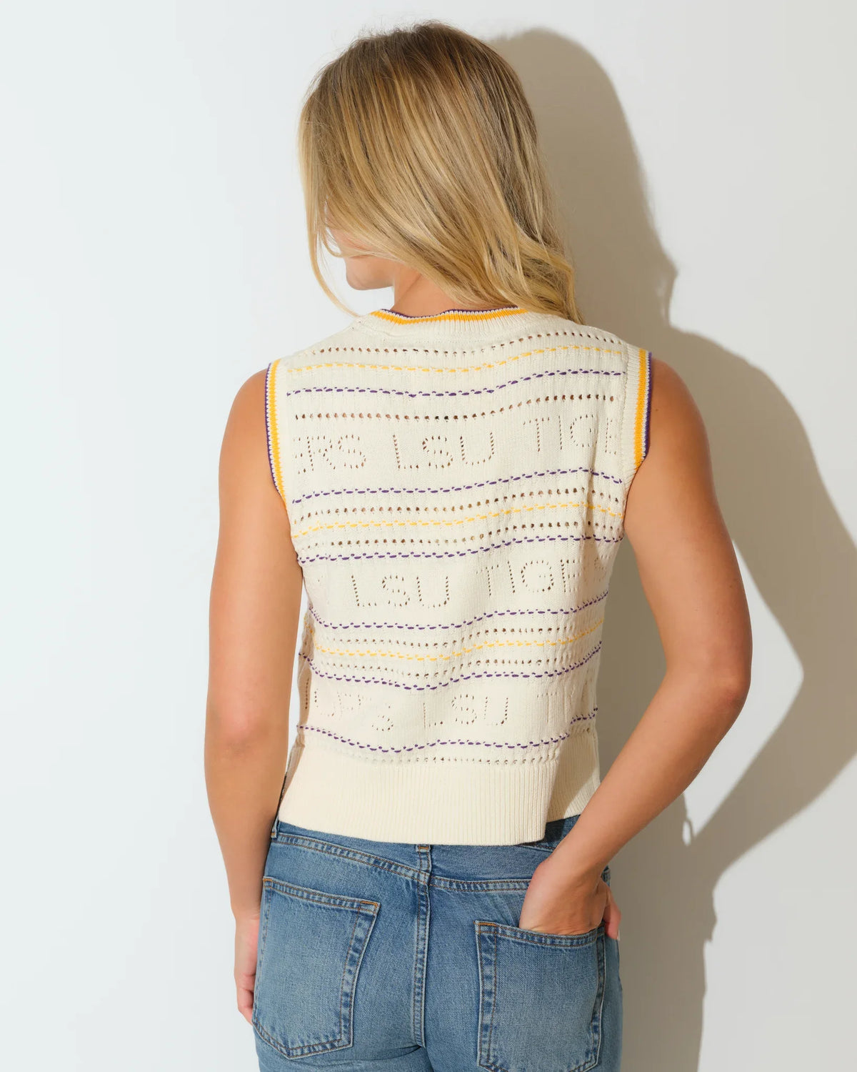 Ivory knit sweater vest for LSU Tigers fans, featuring embroidered team lettering and a striped crew neckline.