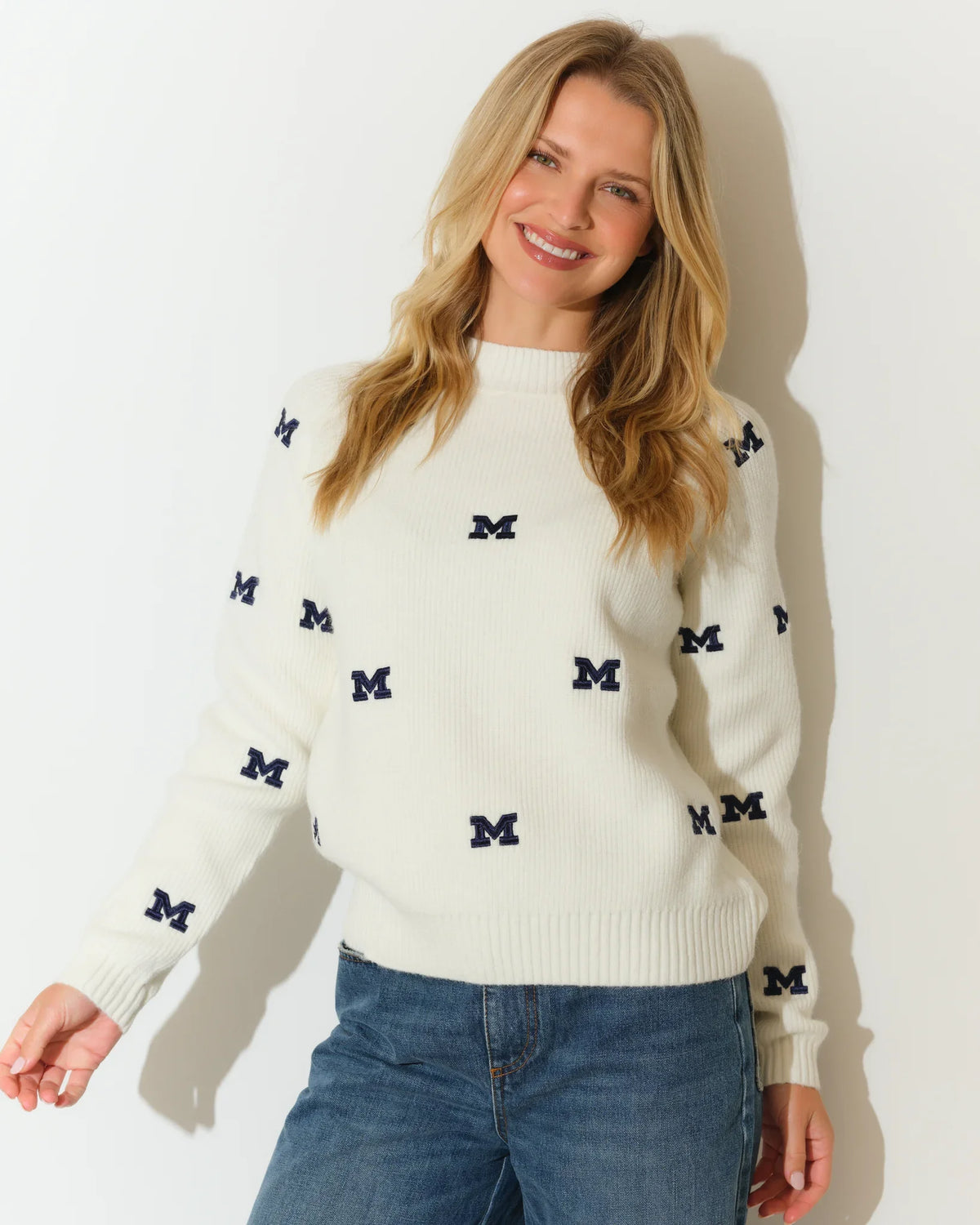Ivory Michigan Wolverines fisherman sweater featuring an allover navy embroidered "M" logo pattern, with a relaxed crew neck silhouette.