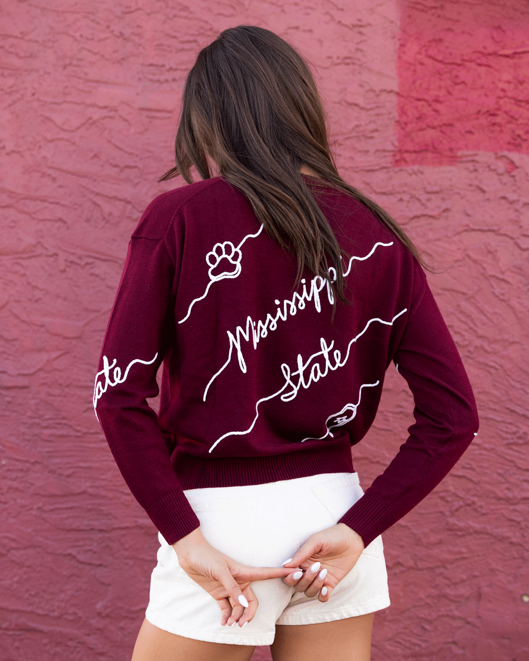 Maroon Mississippi State Bulldogs crew neck sweater with white cursive "Mississippi State" script and decorative wave detailing across the front.