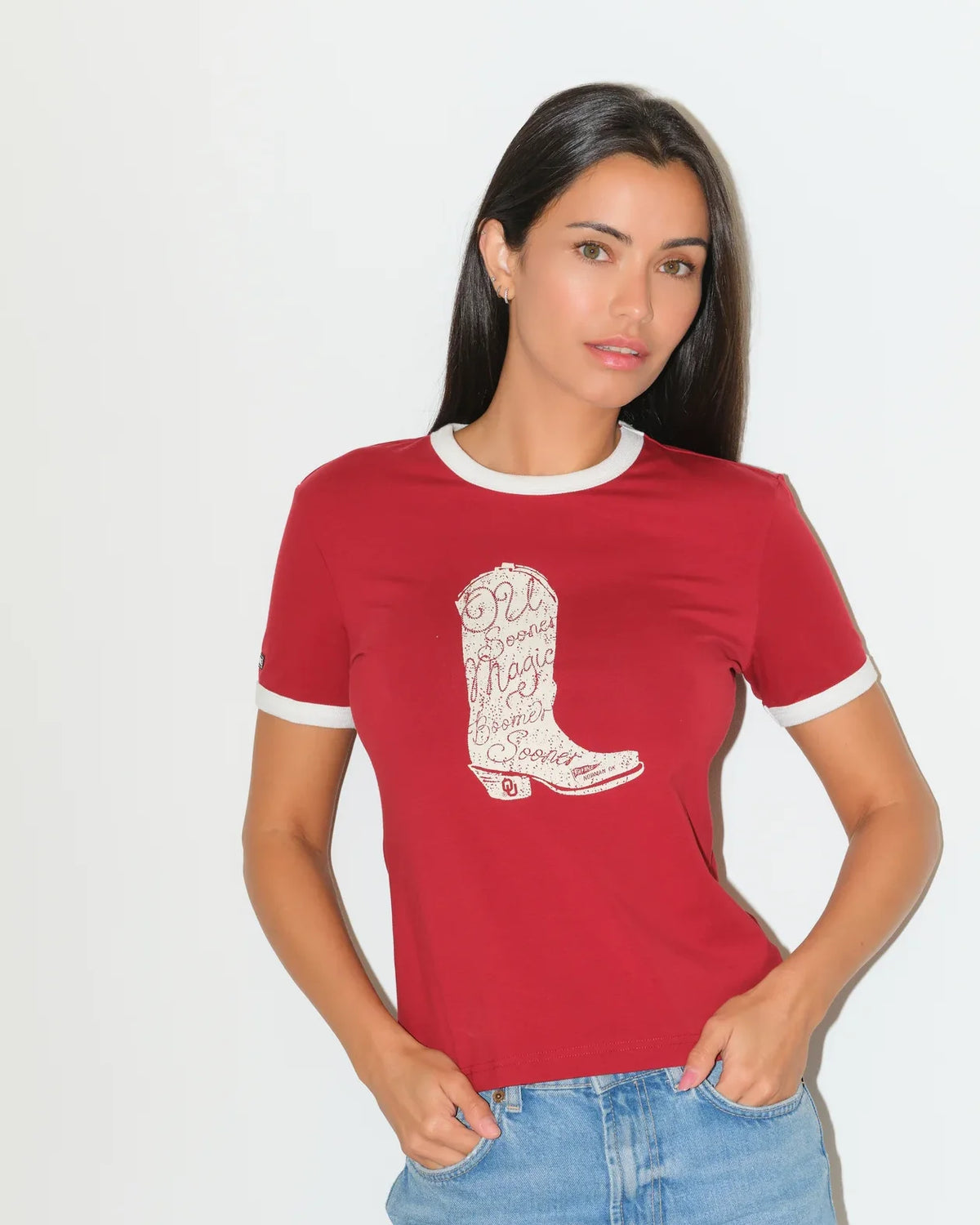 Crimson and white Oklahoma Sooners ringer tee featuring a bold red cowboy boot graphic on the chest.