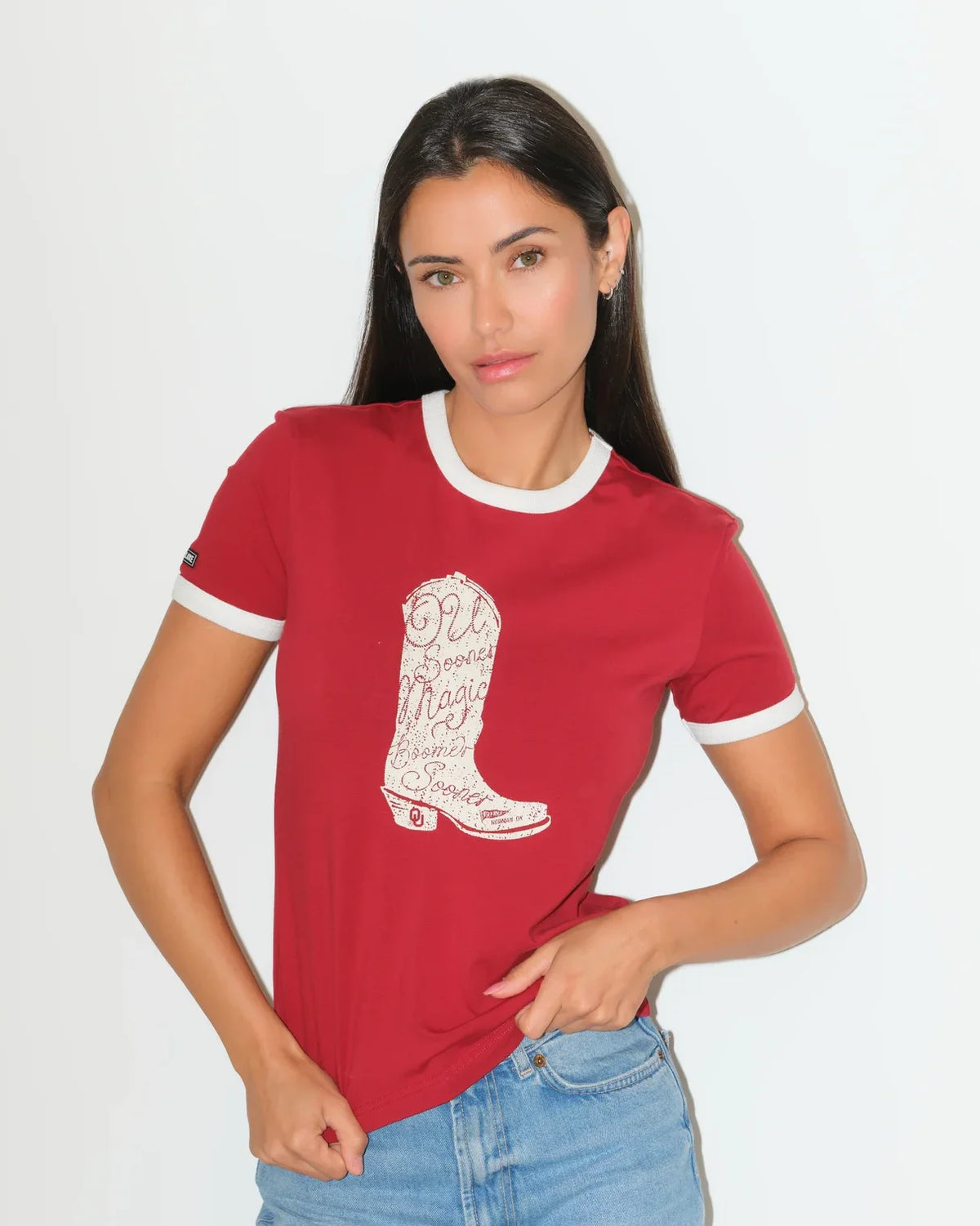 Crimson and white Oklahoma Sooners ringer tee featuring a bold red cowboy boot graphic on the chest.