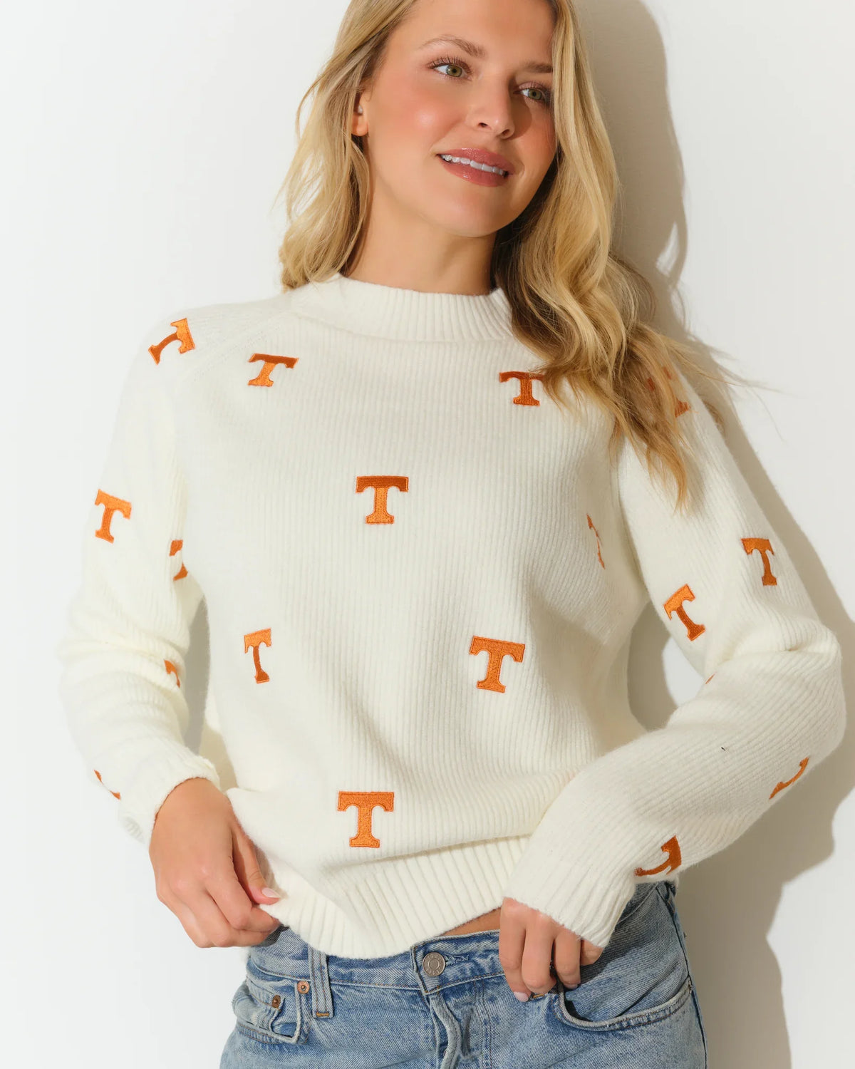 Ivory Tennessee Volunteers fisherman sweater with allover orange embroidered "T" logos, featuring a mock neck and ribbed cuffs.