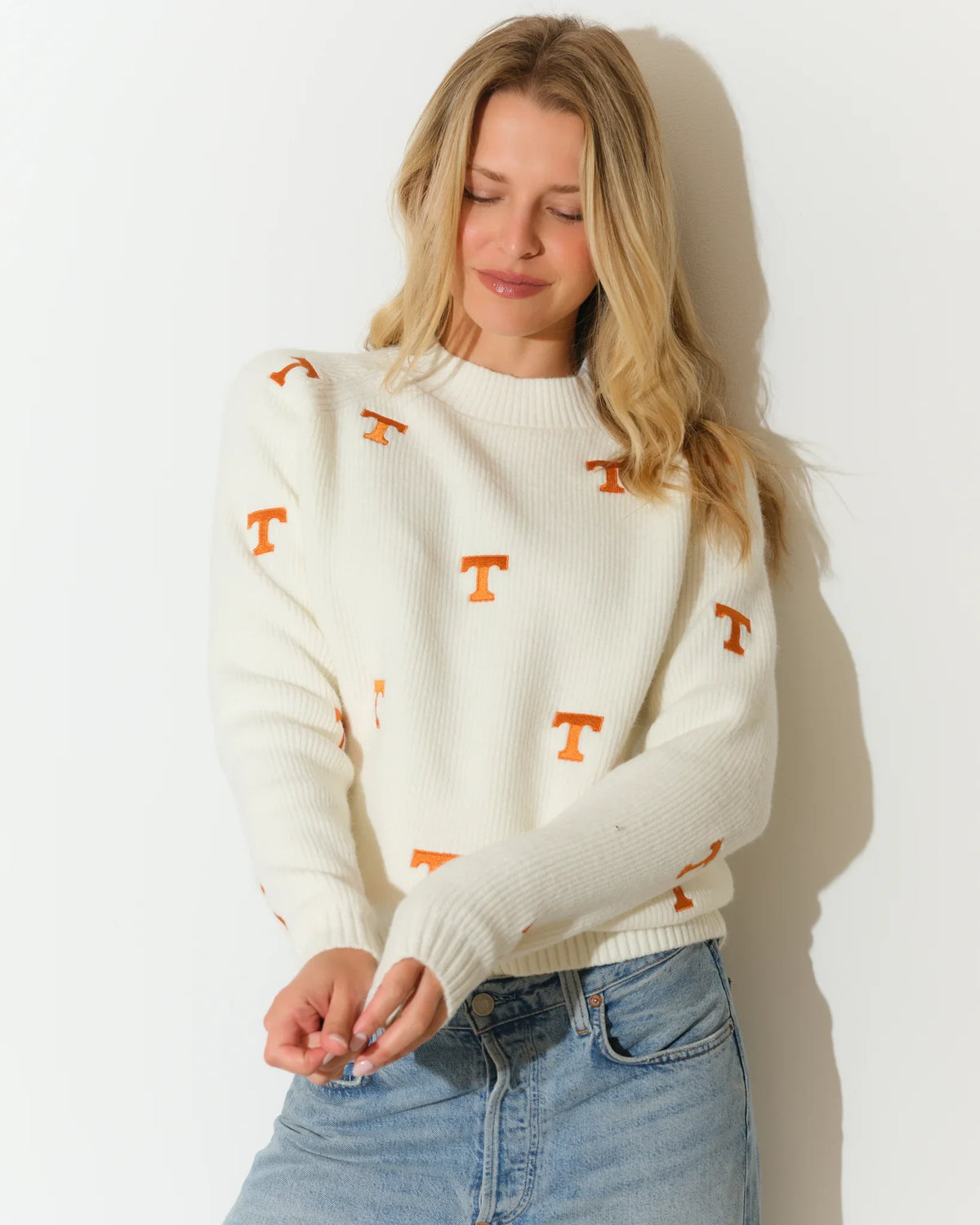 Ivory Tennessee Volunteers fisherman sweater with allover orange embroidered "T" logos, featuring a mock neck and ribbed cuffs.