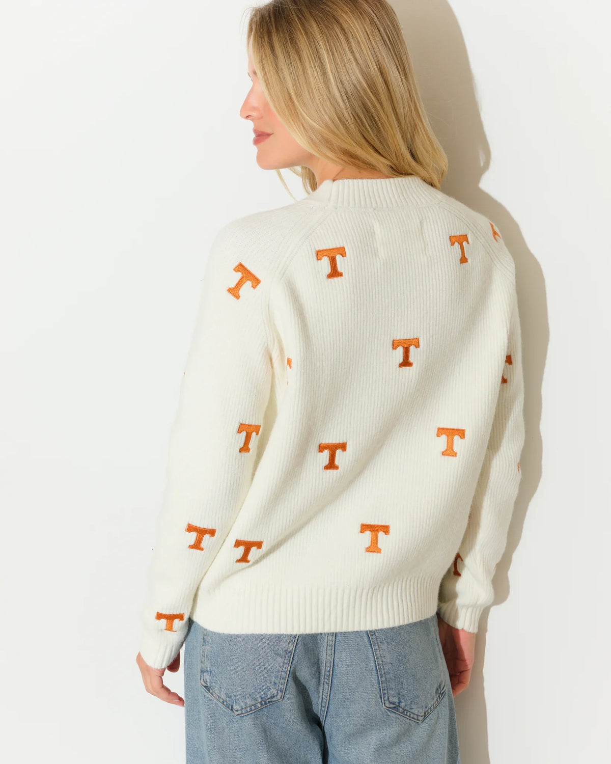Ivory Tennessee Volunteers fisherman sweater with allover orange embroidered "T" logos, featuring a mock neck and ribbed cuffs.