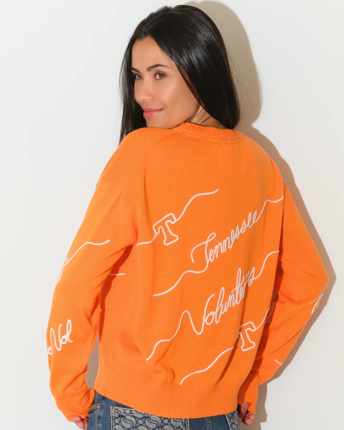 Tennessee Orange Tennessee Volunteers crewneck sweater featuring repeated cursive "Tennessee Volunteers" script across the front and sleeves.