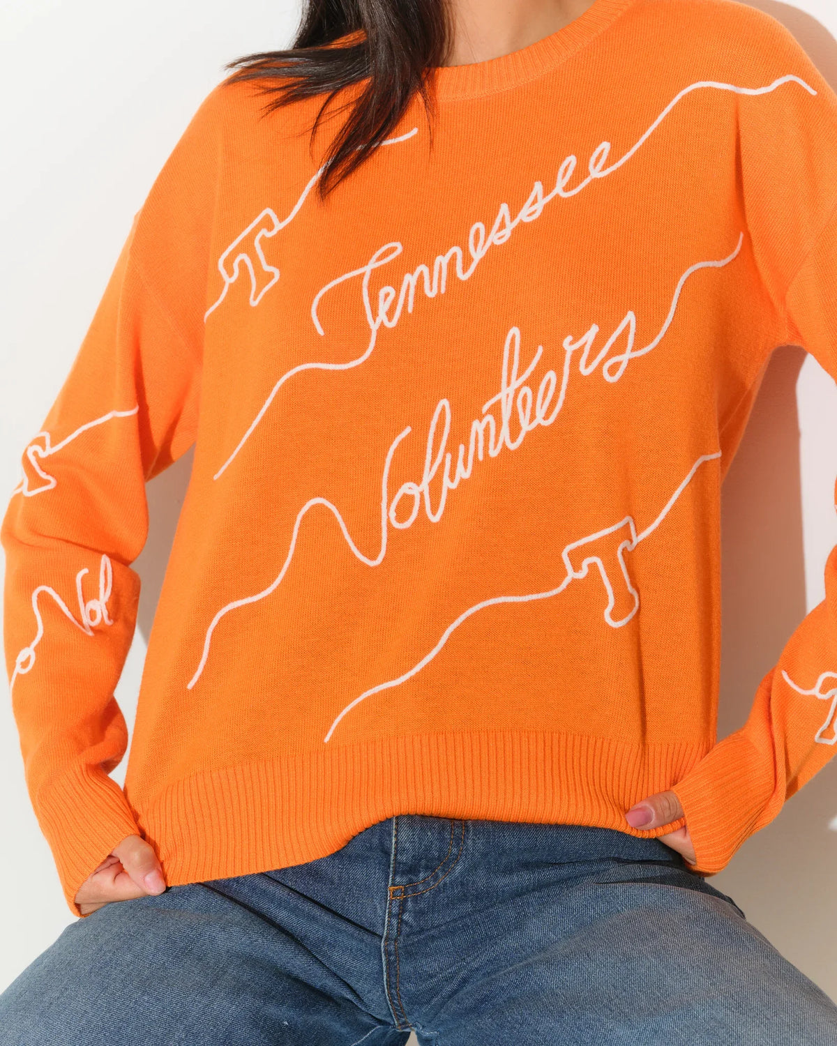 Tennessee Orange Tennessee Volunteers crewneck sweater featuring repeated cursive "Tennessee Volunteers" script across the front and sleeves.