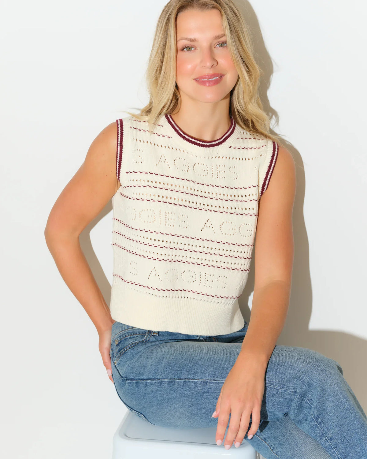 Ivory Texas A&M Aggies knit sweater vest with maroon and navy striped trim at the neckline, featuring textured pointelle-style knit detailing throughout.