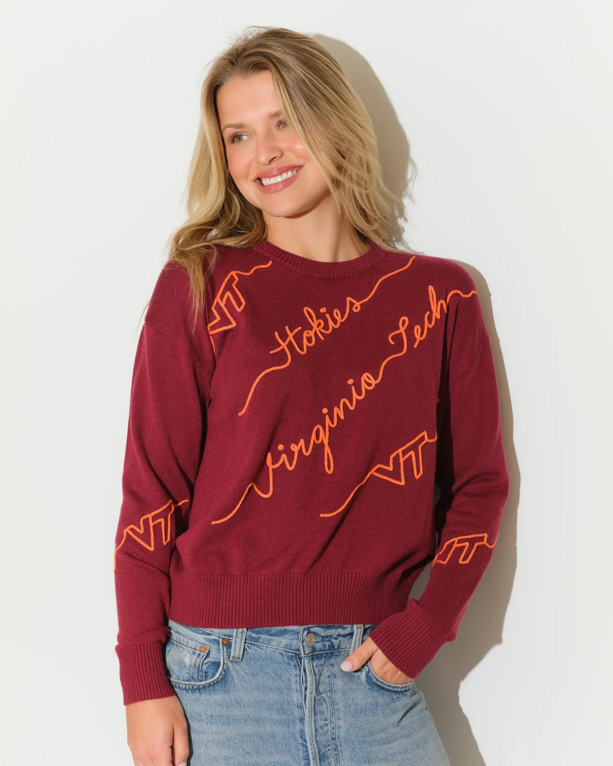 Maroon Virginia Tech crewneck sweater with diagonal orange script "Hokies," "Virginia Tech," and "VT" lettering across the front.