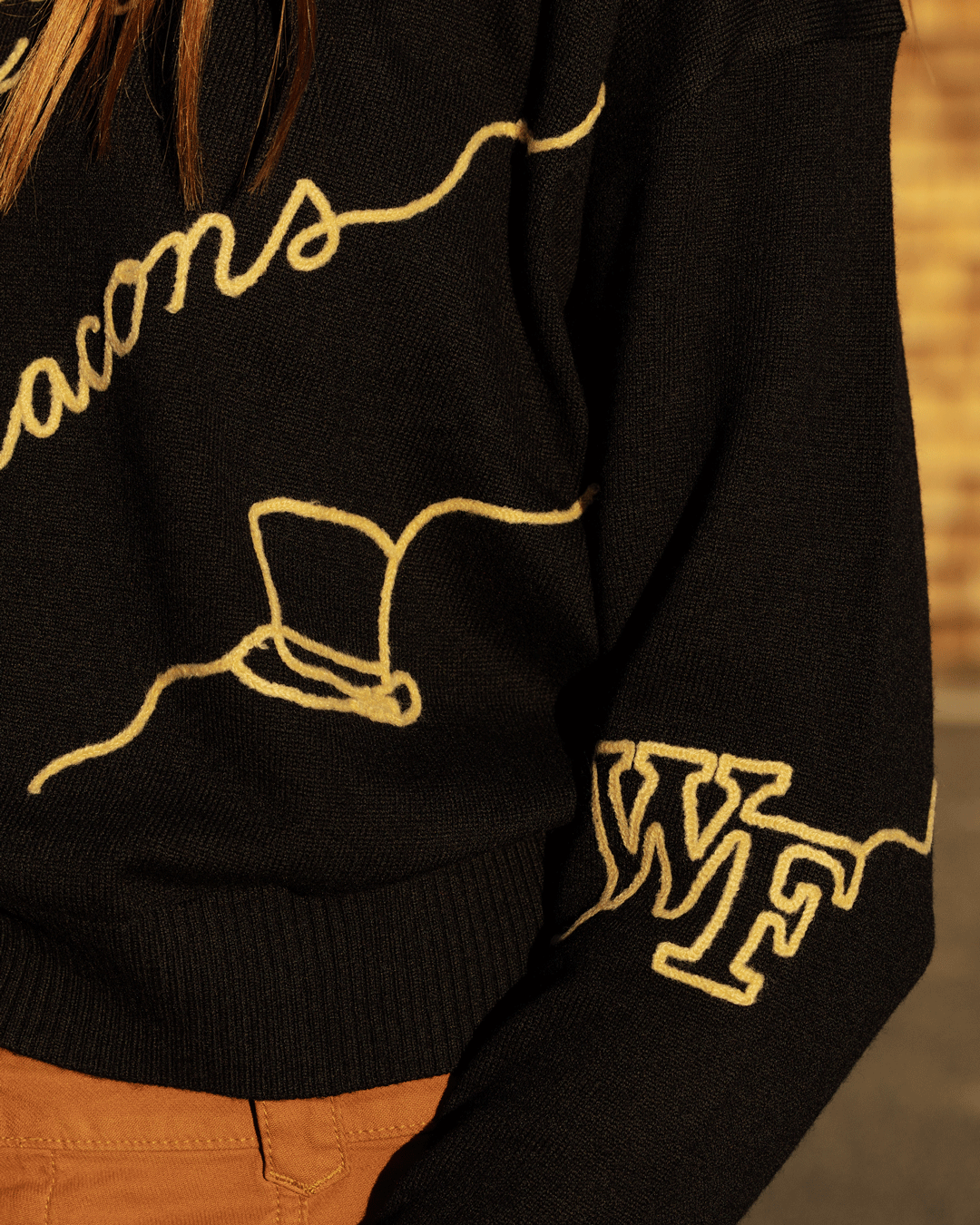 Black long sleeve love letter sweater with wake forest demon deacons embroidery, perfect for school pride and tailgates.