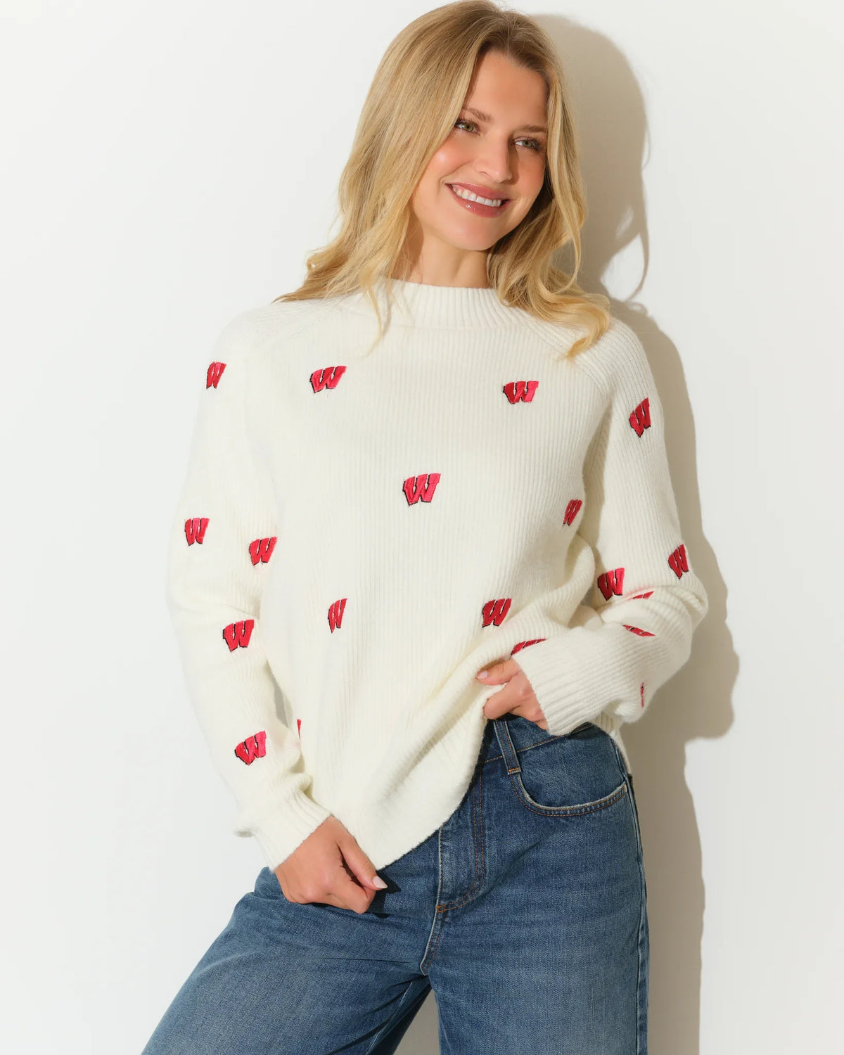 Ivory Wisconsin Badgers fisherman sweater with allover red Badger logo pattern, featuring a relaxed fit and ribbed cuffs.