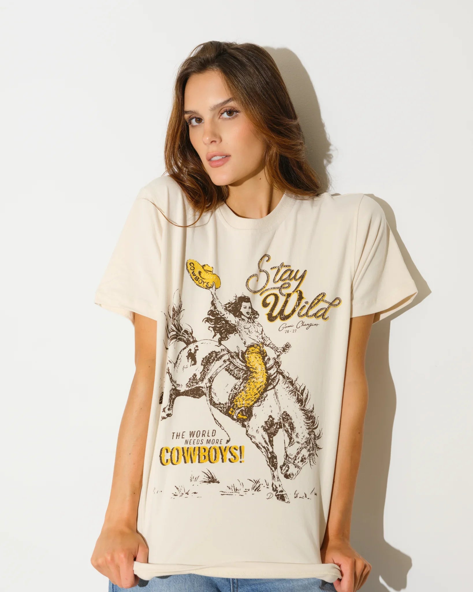 Bone Wyoming Cowboys Game Changer Tee with a vintage-style graphic of a rodeo rider and "Stay Wild" text, shown in a relaxed fit.