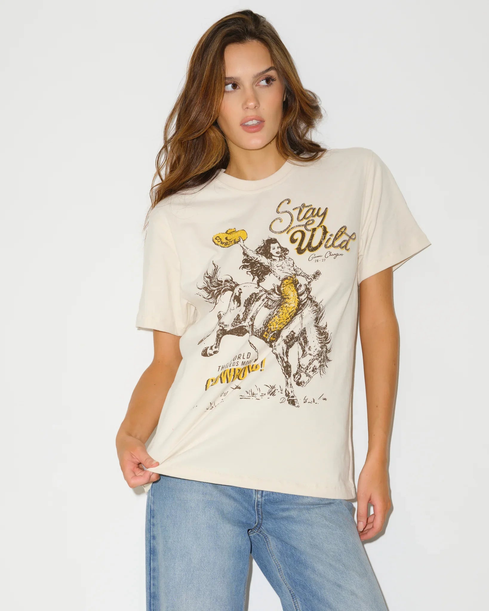 Bone Wyoming Cowboys Game Changer Tee with a vintage-style graphic of a rodeo rider and "Stay Wild" text, shown in a relaxed fit.