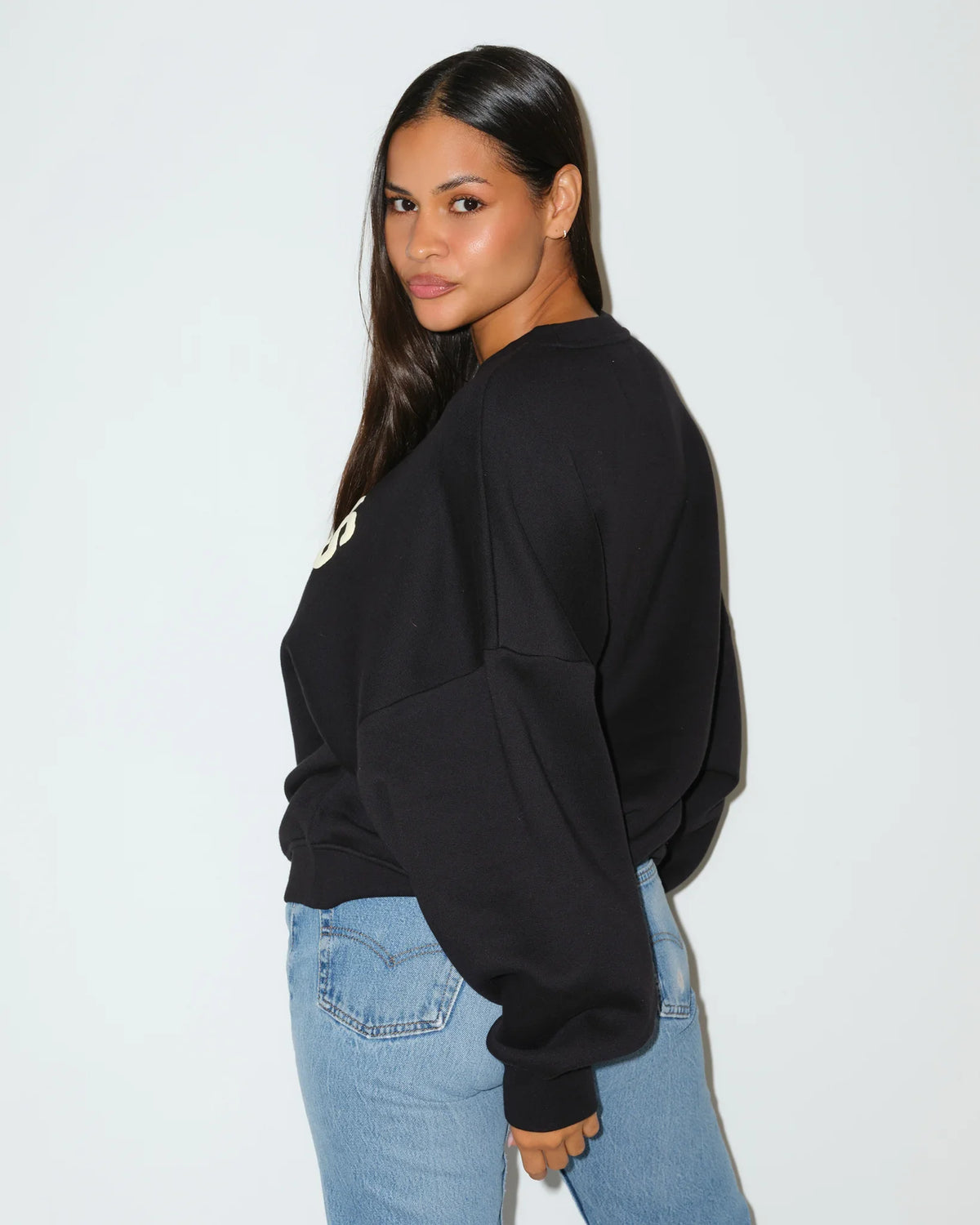 Black KadyLuxe balloon sleeve crew sweatshirt with cream "SUNDAYS" graphic lettering across the chest, featuring oversized dropped shoulders.