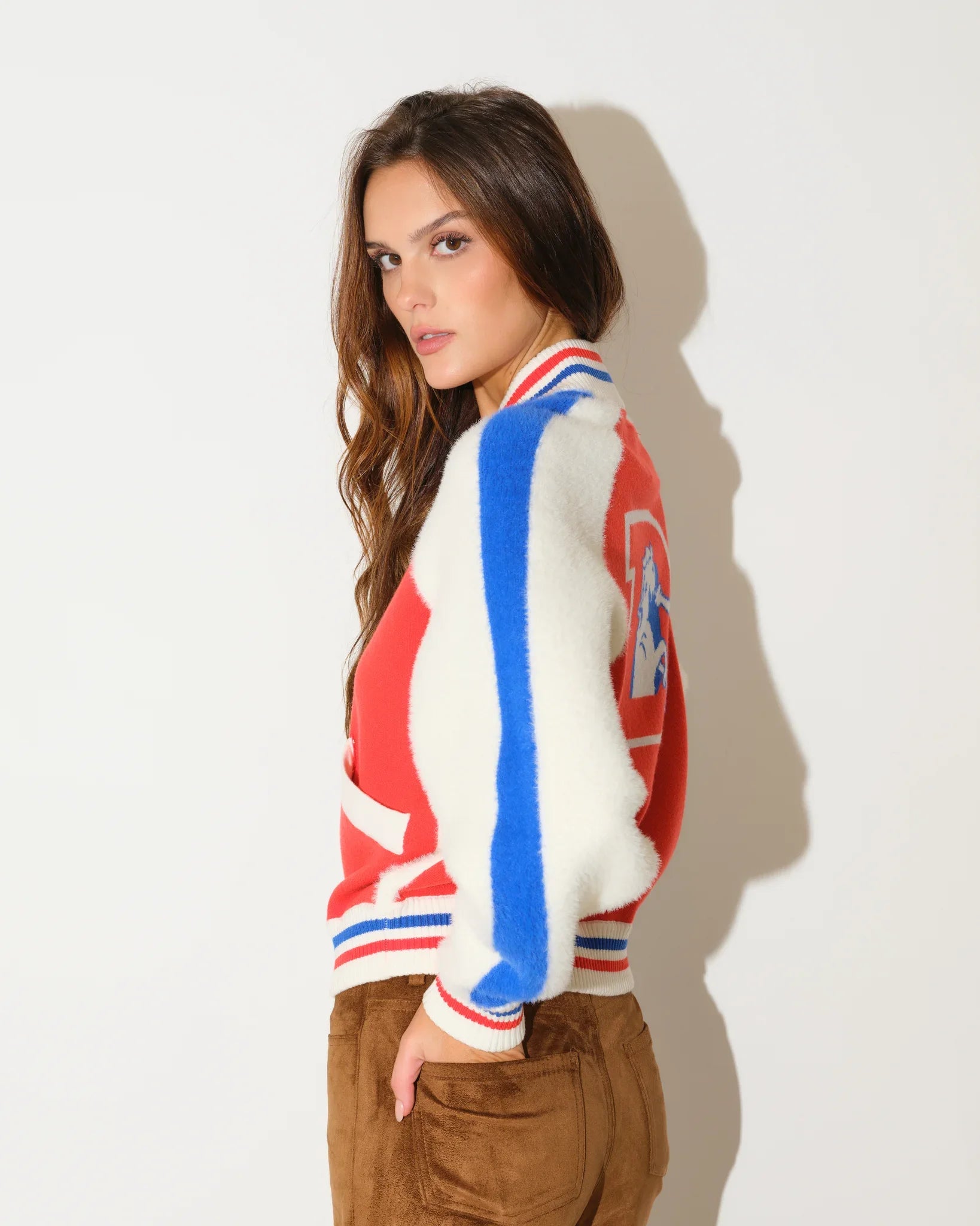 Orange Denver Broncos faux fur knit bomber jacket with red and blue colorblock panels, stripe trim, and a large "B" logo on the chest.