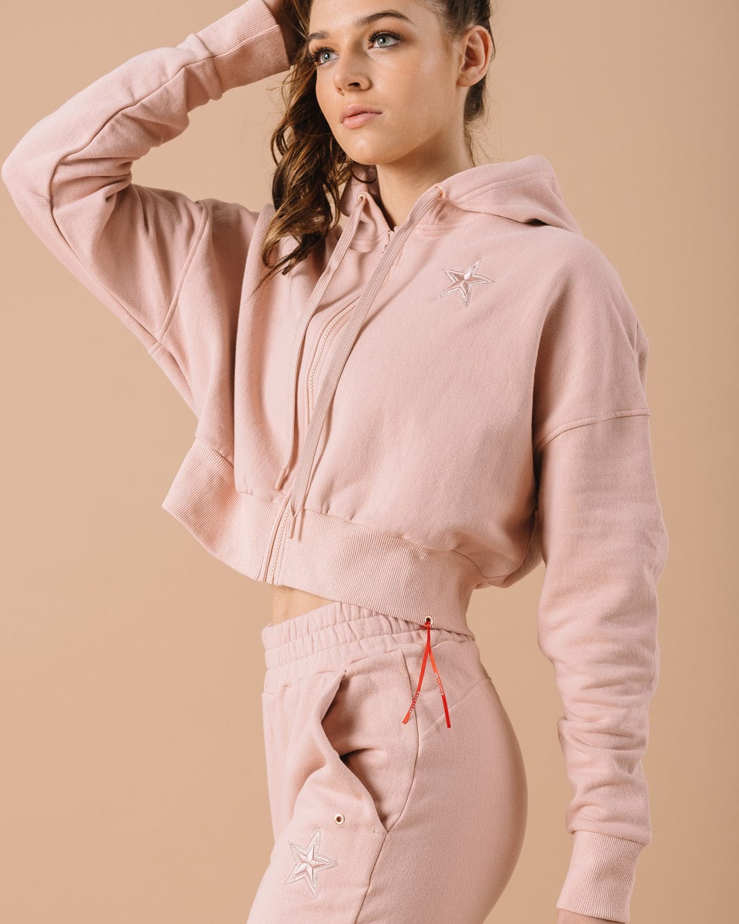 Pink hoodie with Dallas Cowboys star logo, great for casual fan style or weekend lounging.