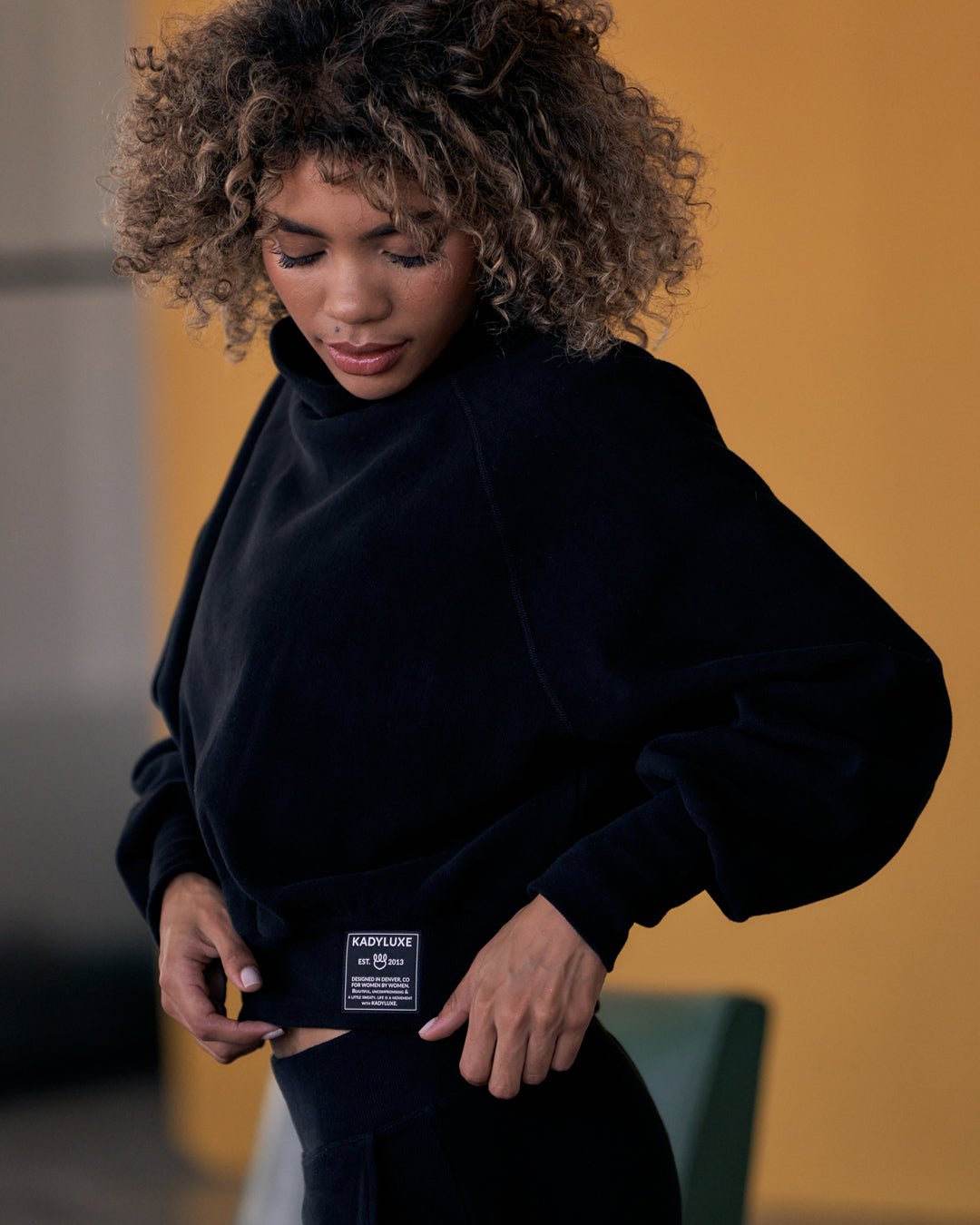 Side view of KADYLUXE® Corduroy Turtleneck Pullover in Black