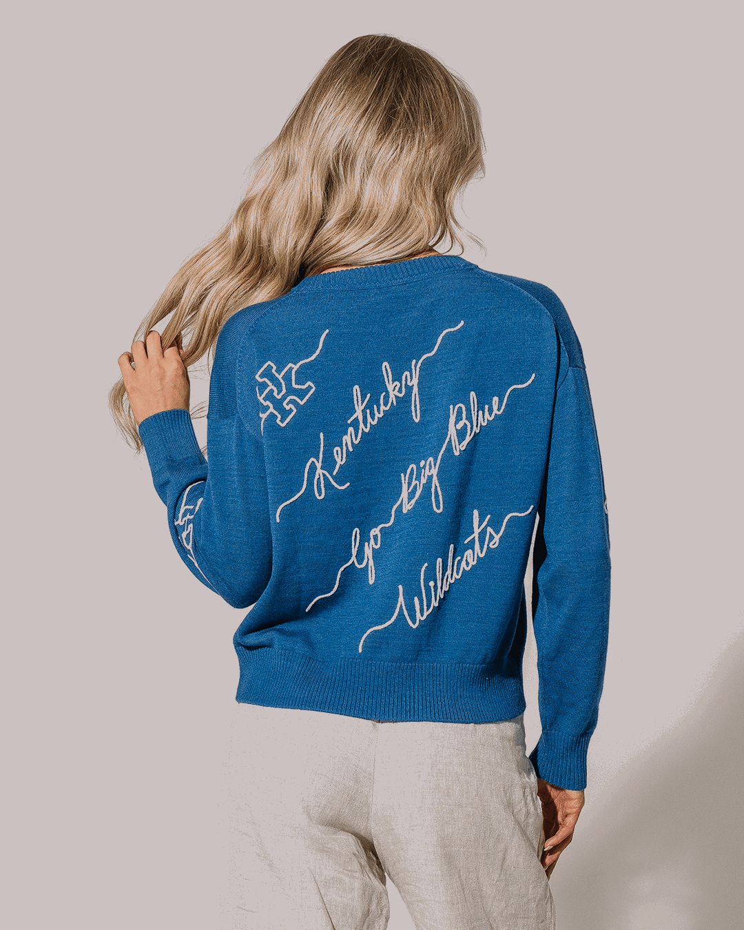 blue long sleeve sweater with kentucky wildcats embroidery, styled for college basketball season