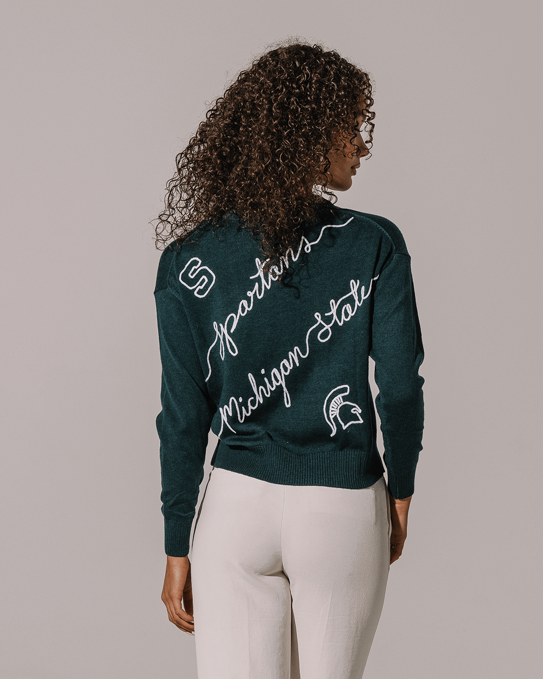 green long sleeve sweater with michigan state spartans embroidery, perfect for college game day looks