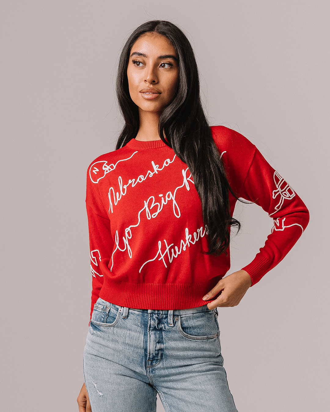 red crewneck sweater with nebraska cornhuskers embroidery, styled for college game day and tailgates