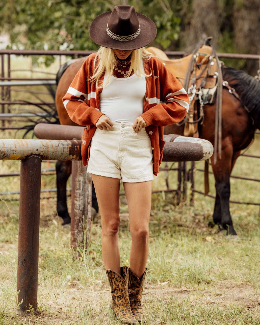 Burnt orange button up cardigan with texas longhorns embroidery, styled for tailgates, campus, and game days.