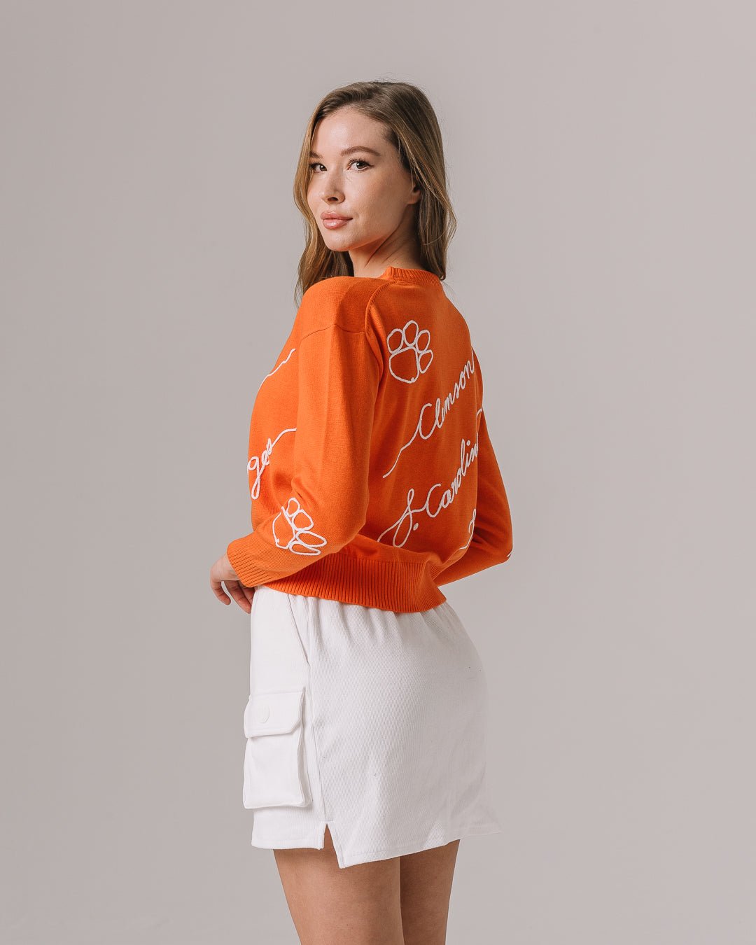orange long sleeve sweater with clemson tigers embroidery, styled for college tailgate